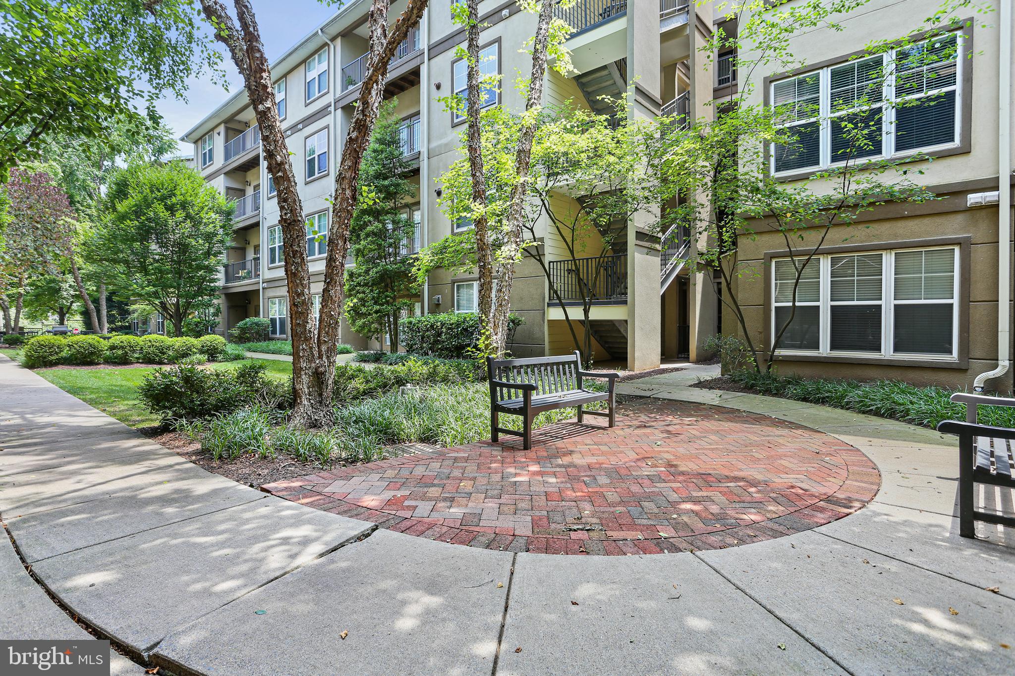 a view of a brick building with a bench in front of building