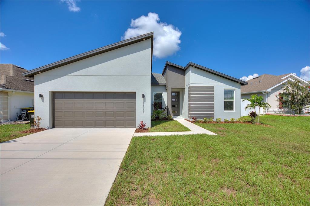 a front view of a house with a yard and garage