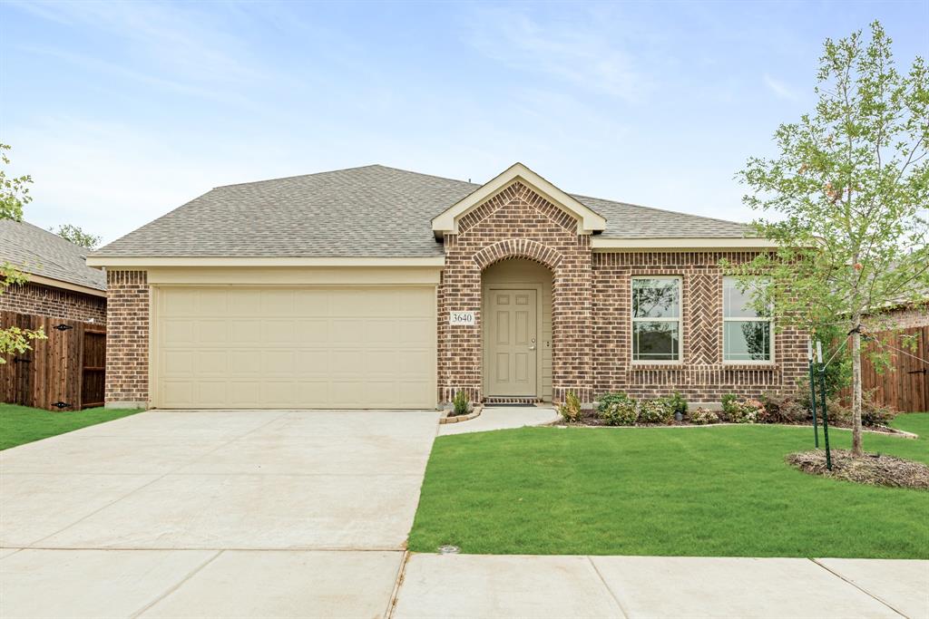 a front view of a house with a garden and yard