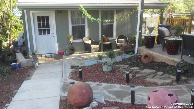 a front view of a house with outdoor seating