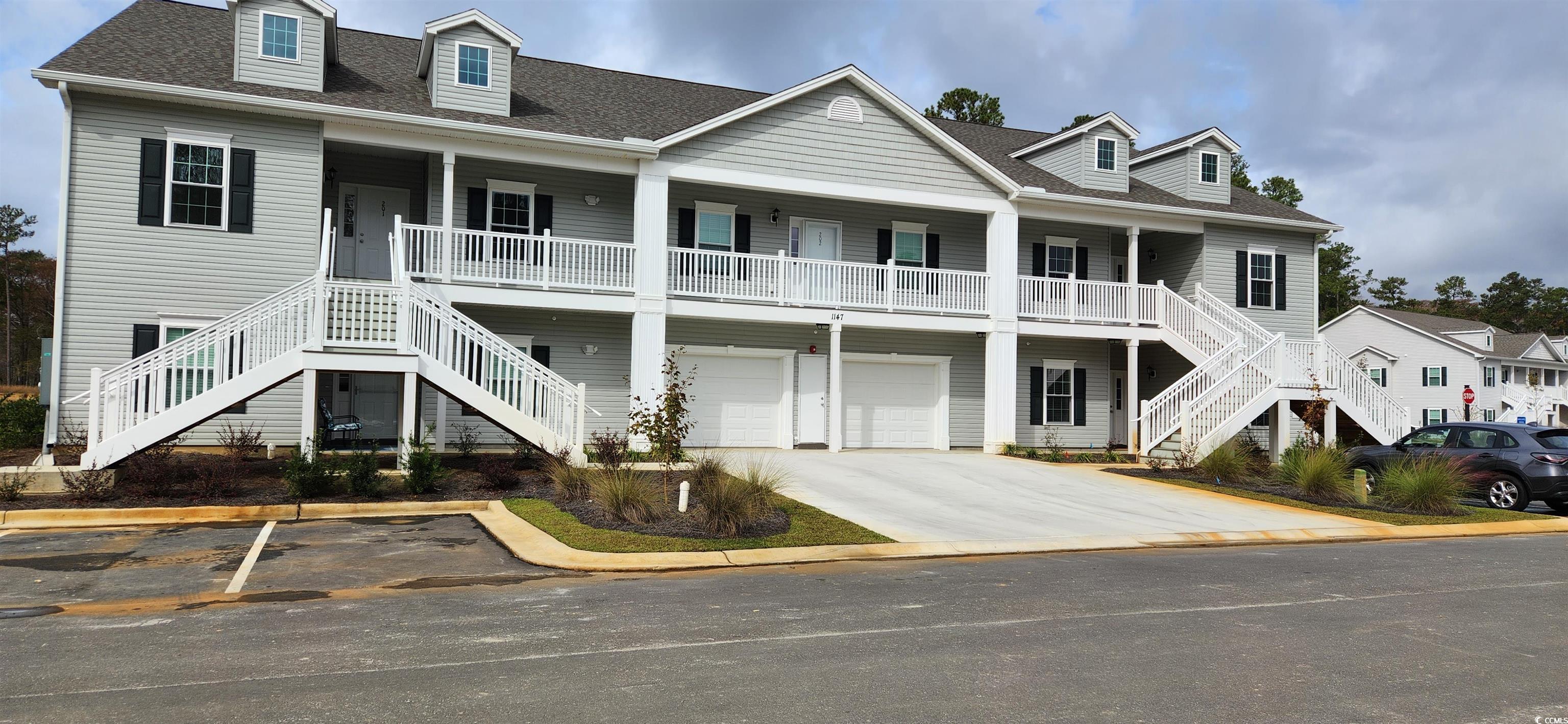 Beach home with a garage and a porch