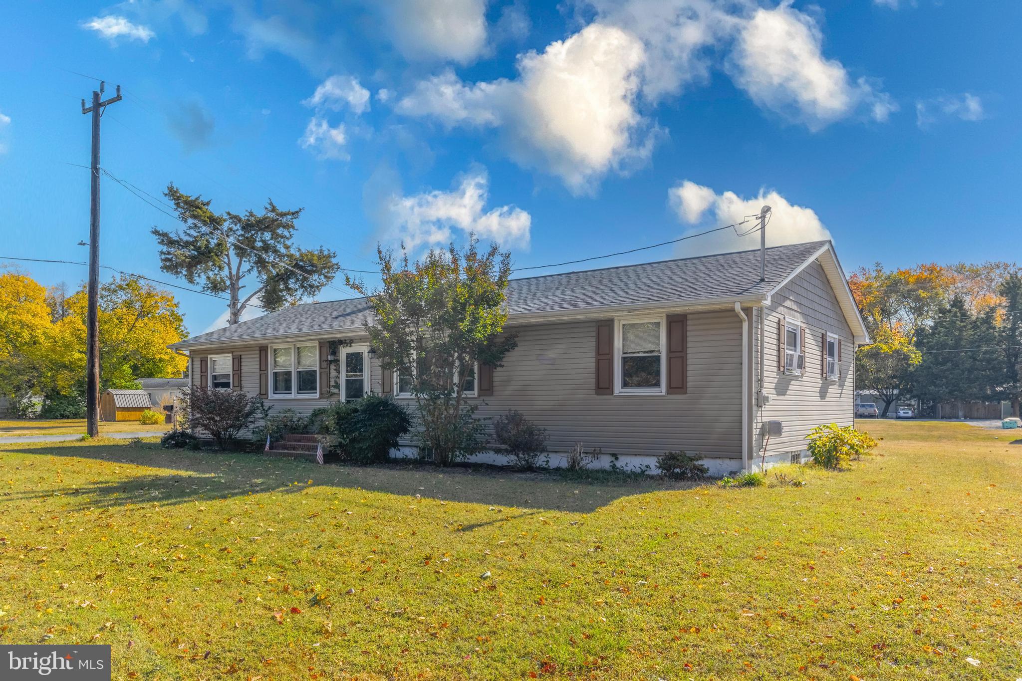 a front view of house with yard and trees