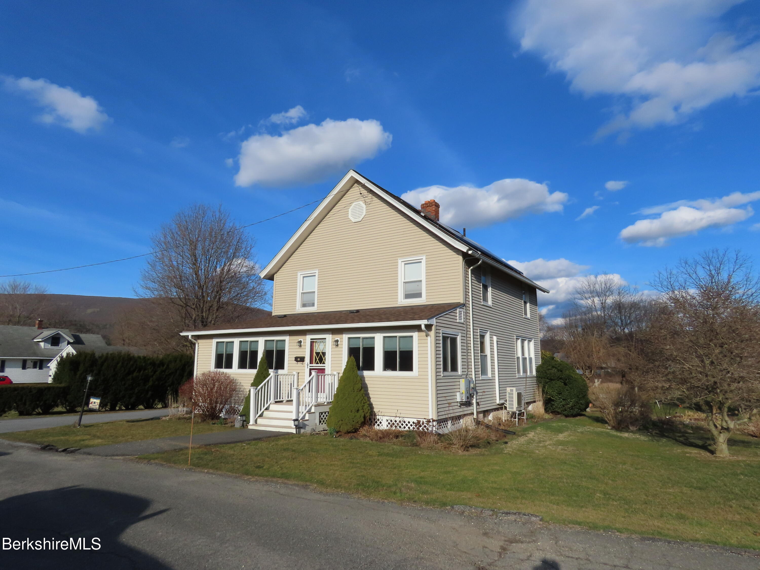 a front view of a house with a garden