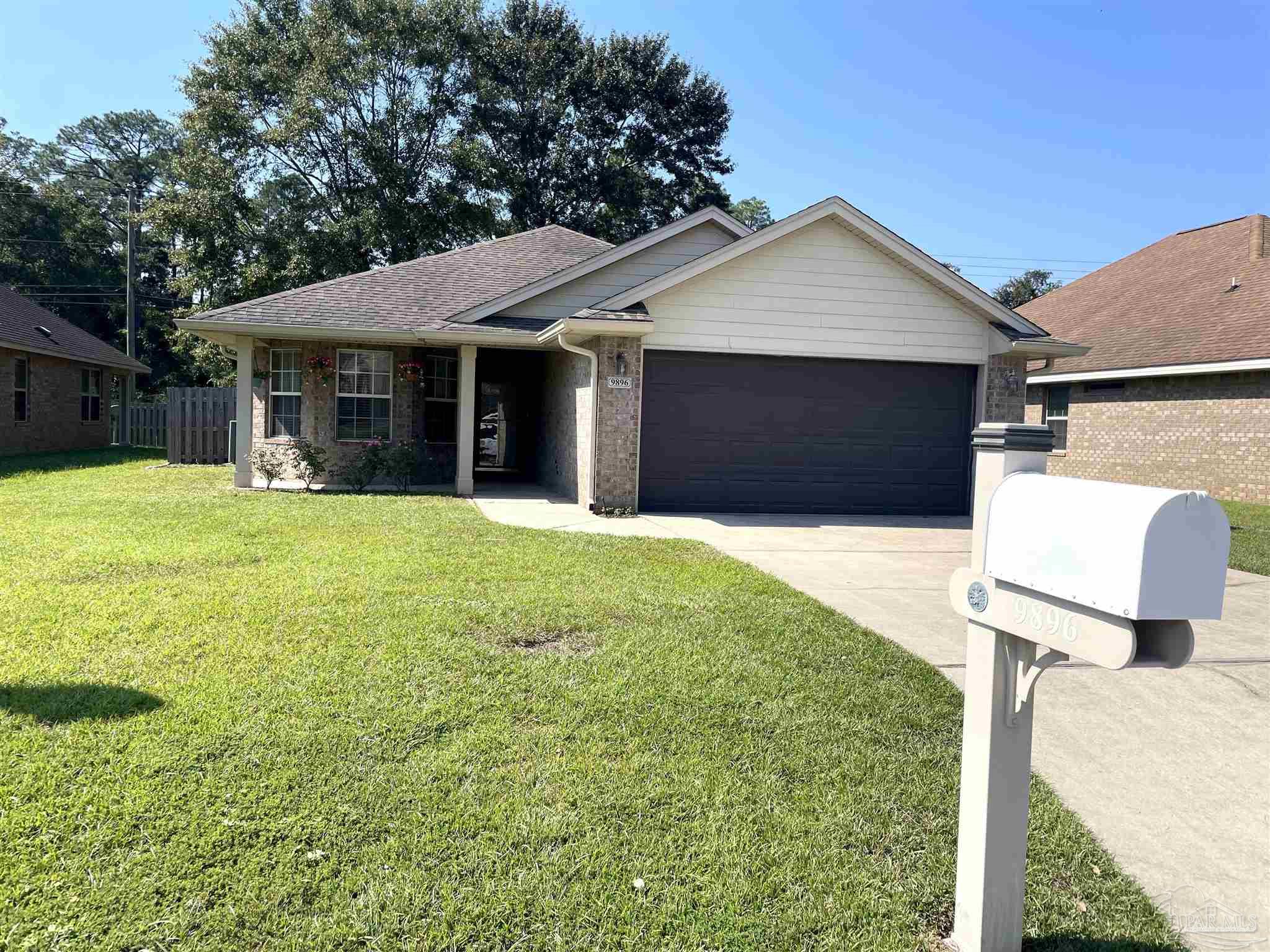 a front view of a house with a yard and garage