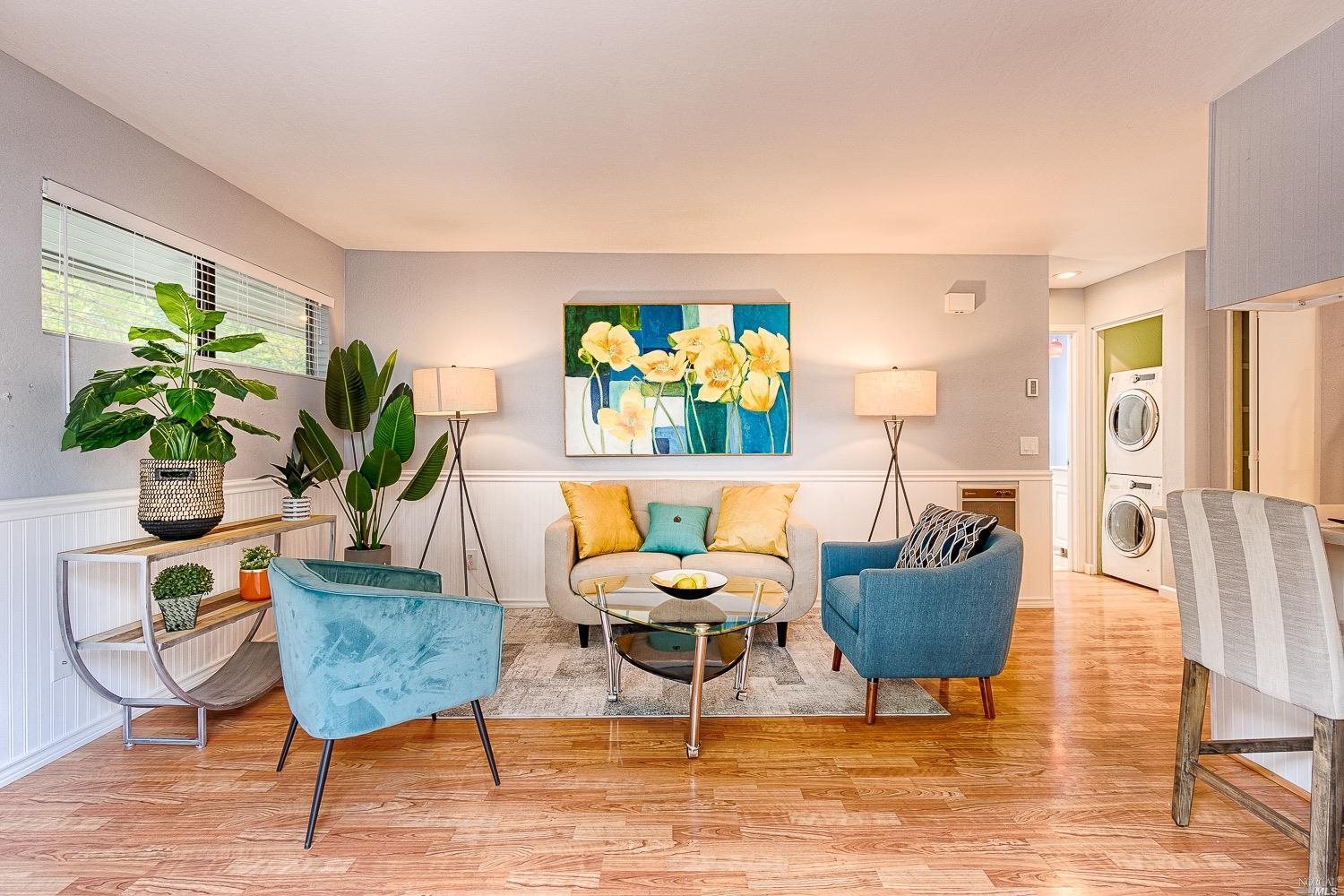 a living room with furniture potted plant and a table