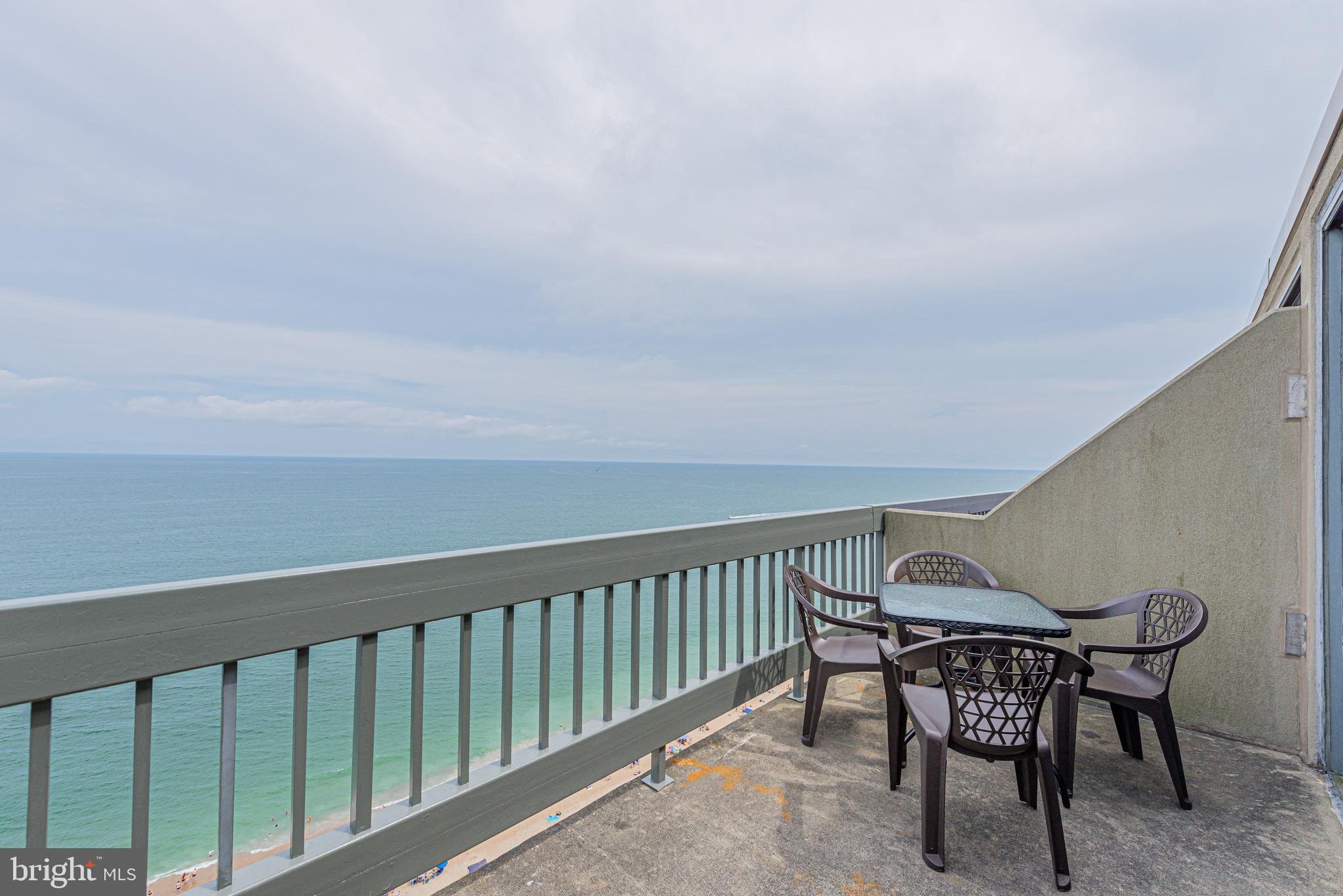 a view of a chairs and table in the balcony