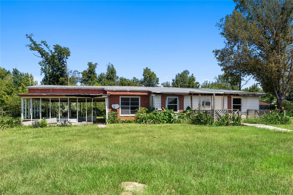 a front view of a house with a yard and trees