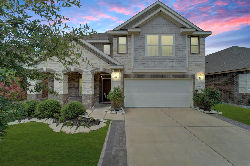 a front view of a house with a yard and garage