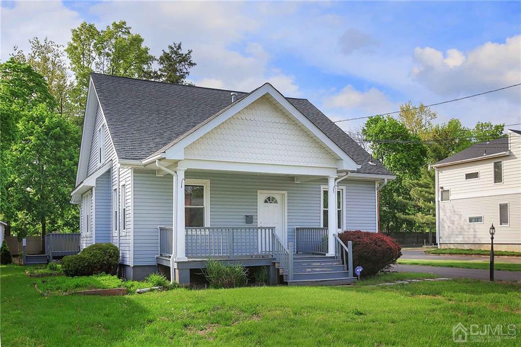 a view of house with backyard and garden