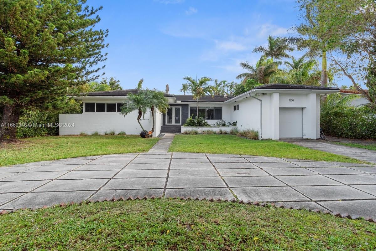 a front view of house with yard and green space