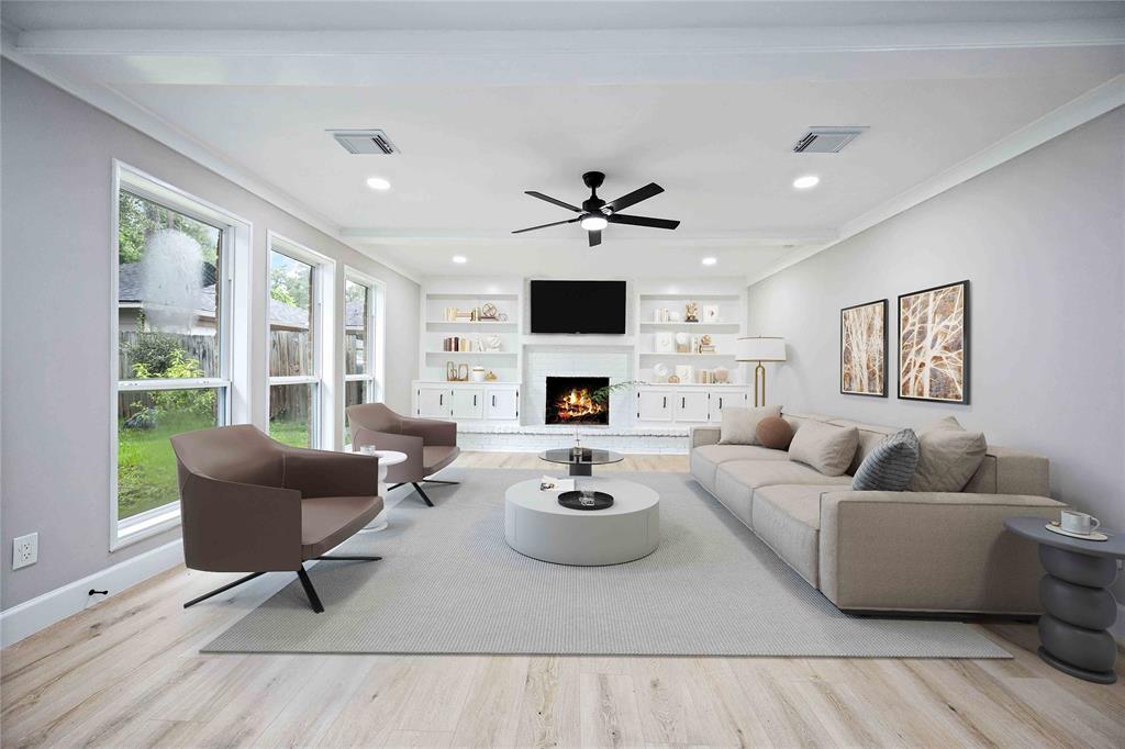 a living room with furniture fireplace and a large window