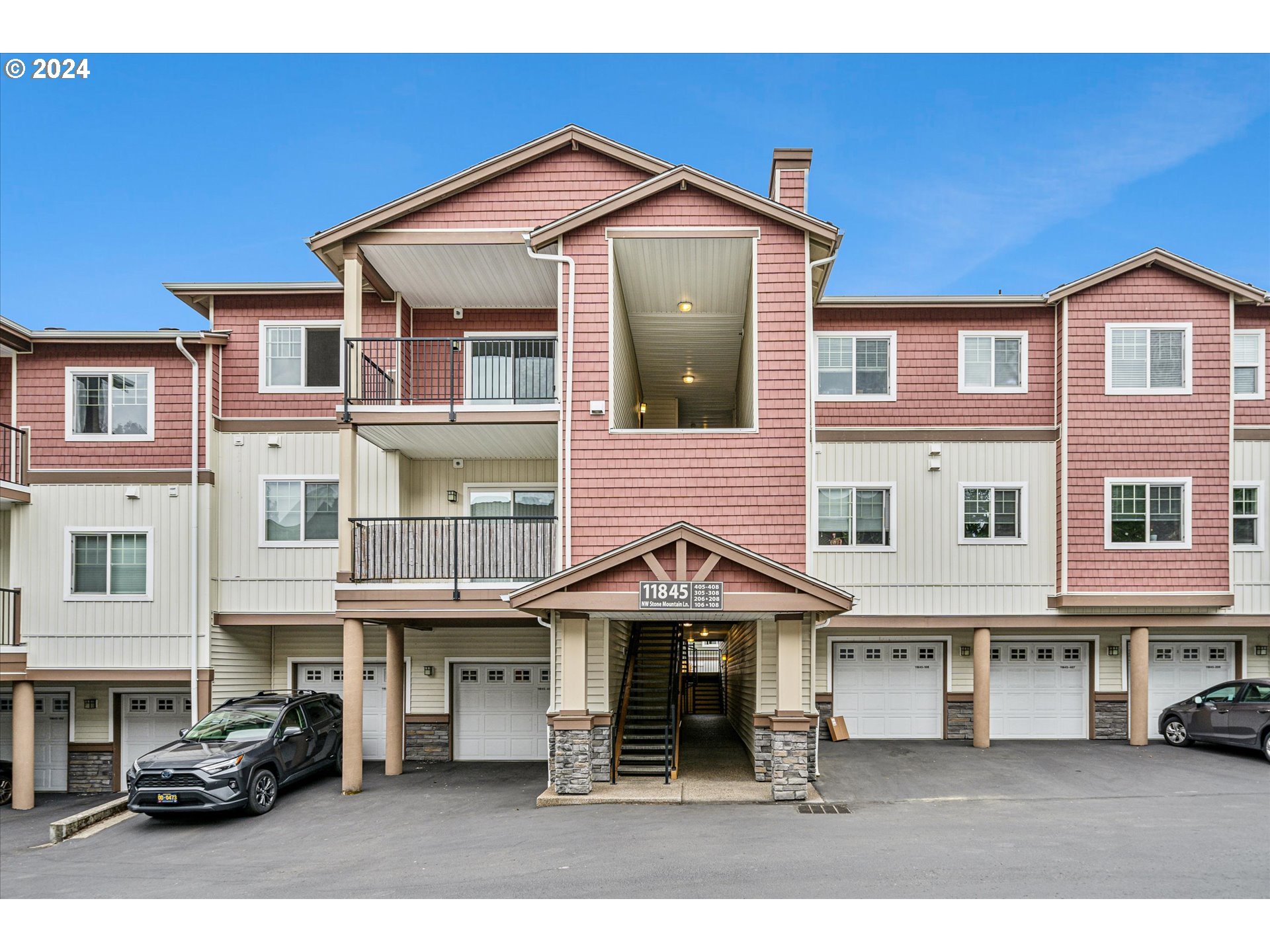 a front view of a residential apartment building with a yard