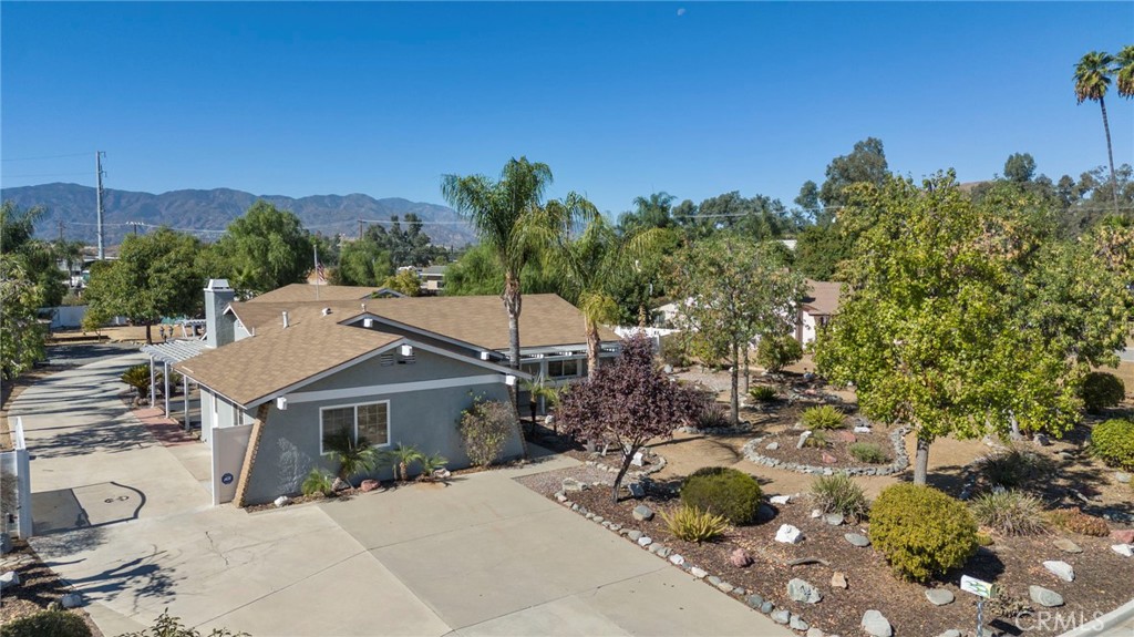 a view of a house with a yard and tree s