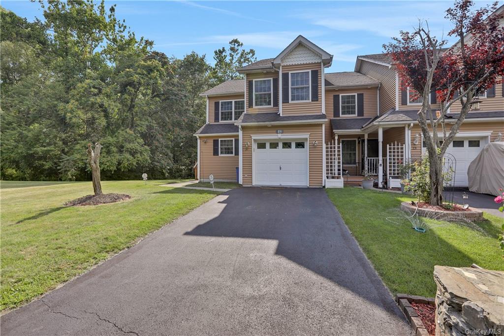 a front view of house with yard and green space