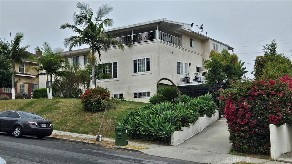 a front view of a house with a garden