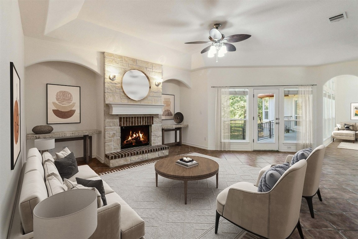 a living room with furniture a fireplace and a large window