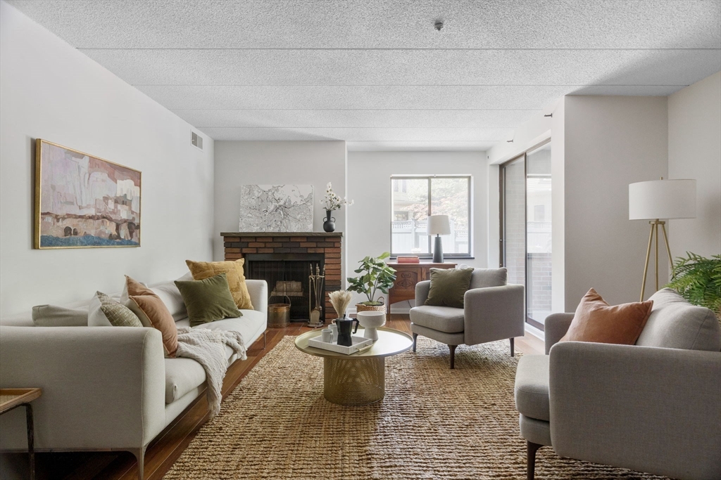 a living room with furniture and a fireplace