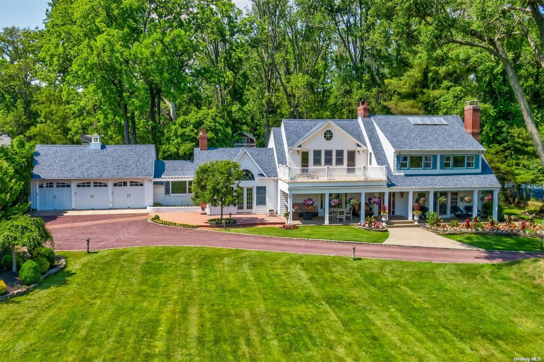 an aerial view of a house with a big yard and large trees