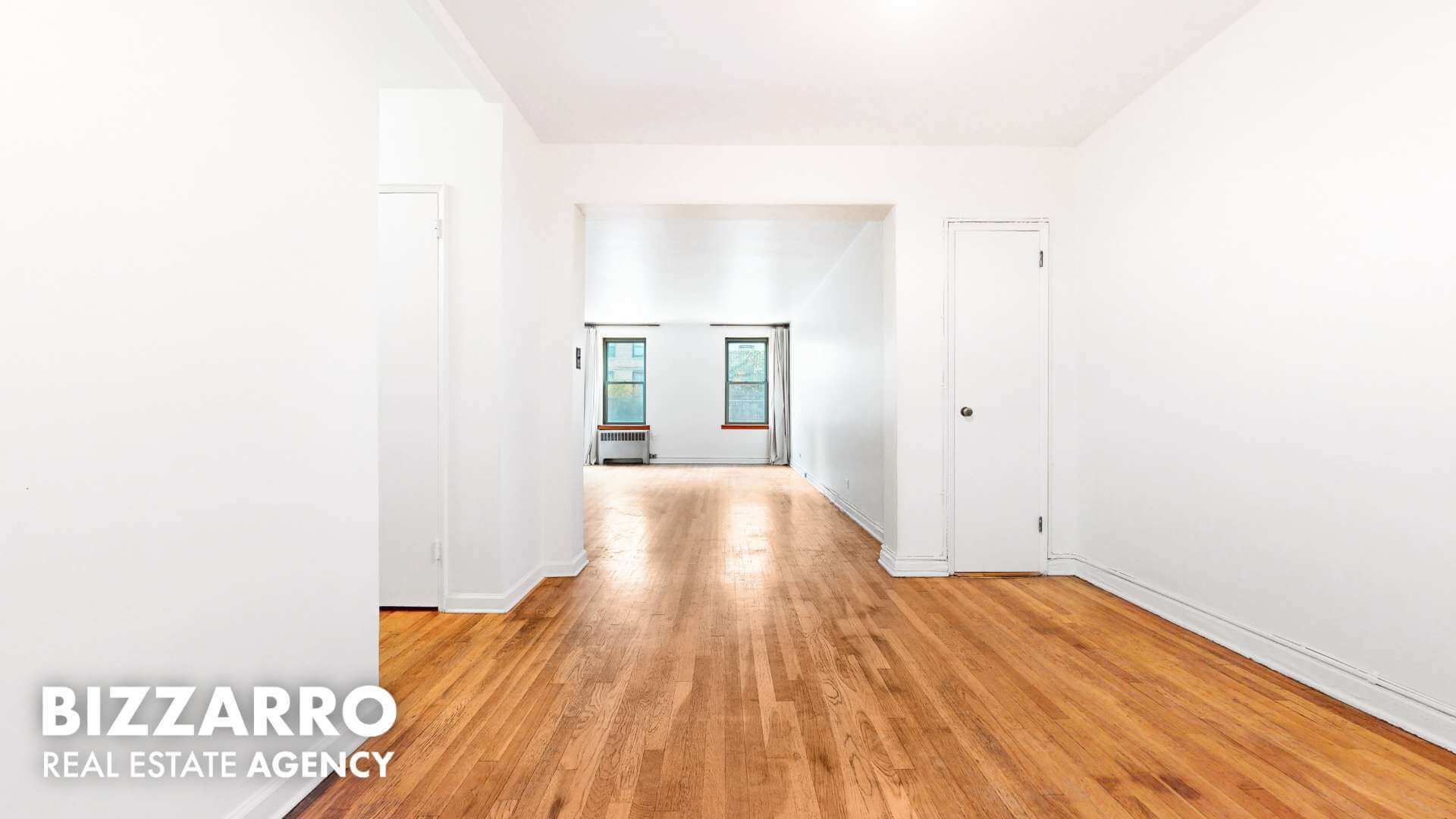 a view of a room with wooden floor and a sink