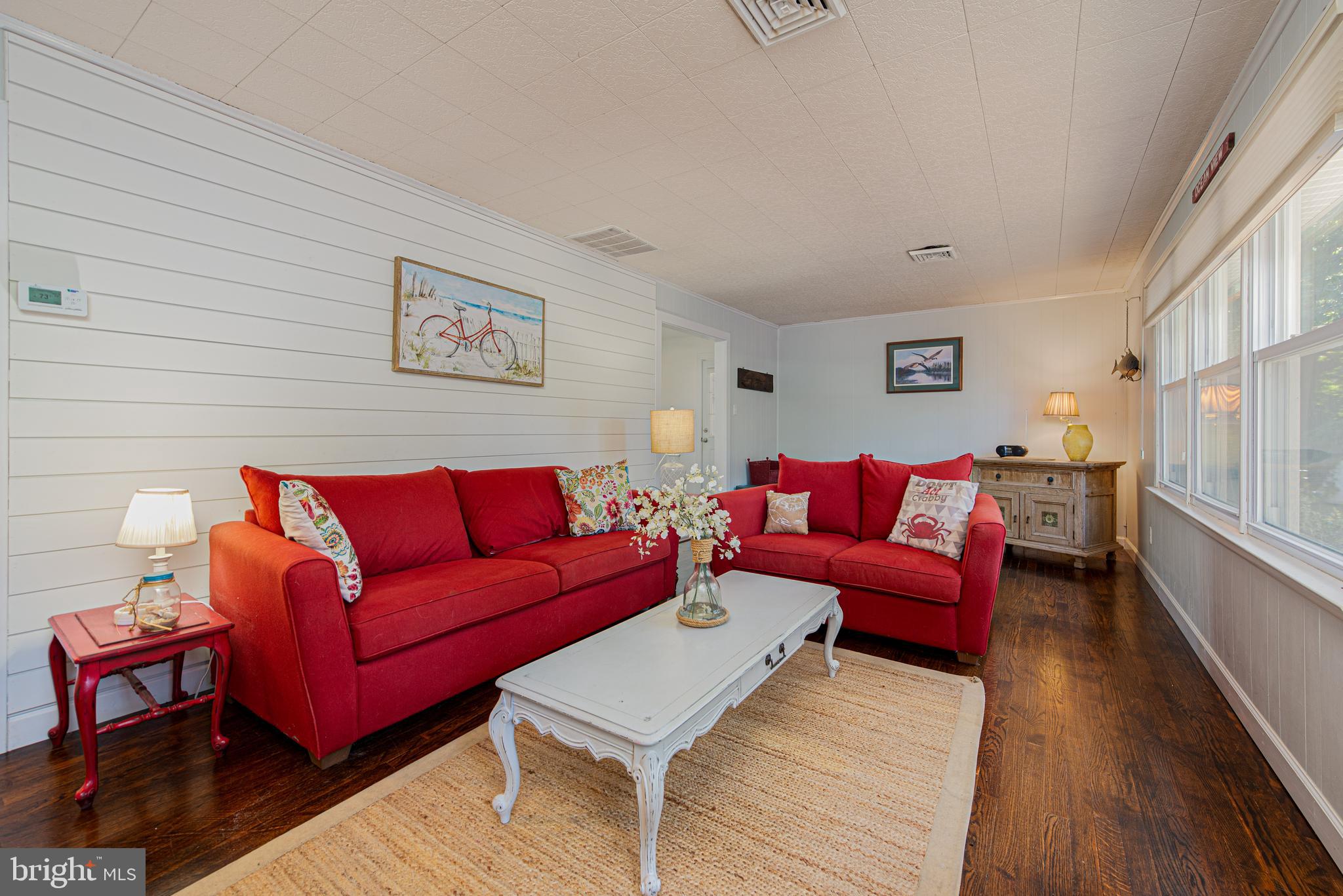 a living room with furniture a couch and wooden floor