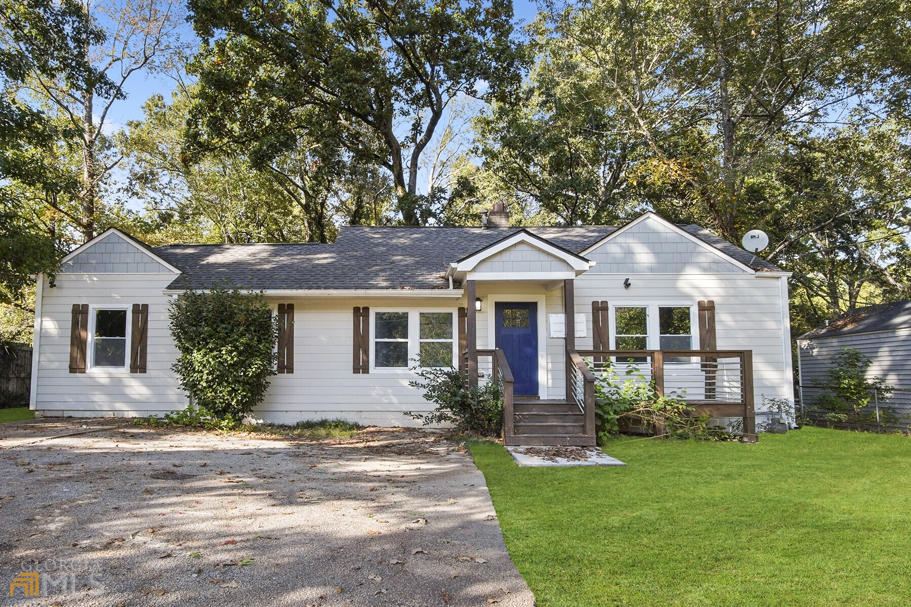 a front view of a house with a garden