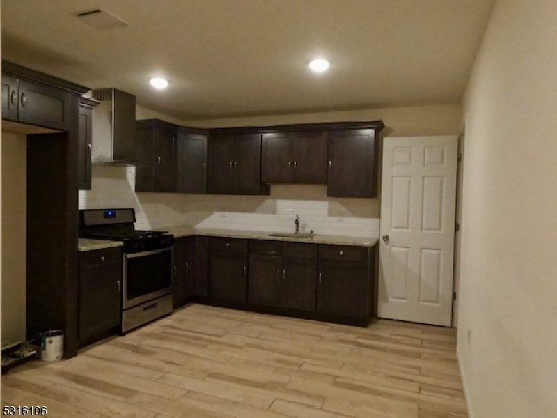 a kitchen with a refrigerator and a sink