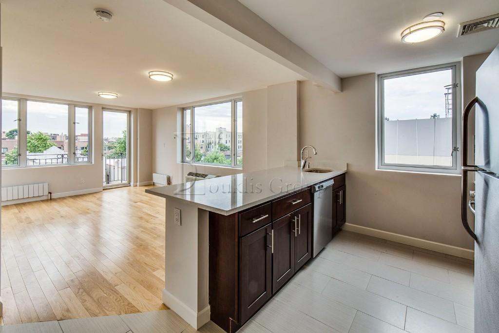 a kitchen with stainless steel appliances granite countertop a sink and a stove