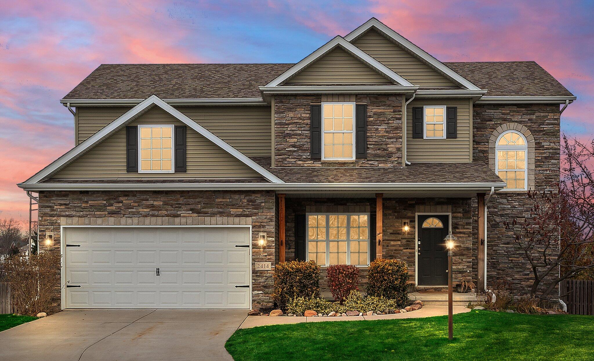 a front view of a house with a yard