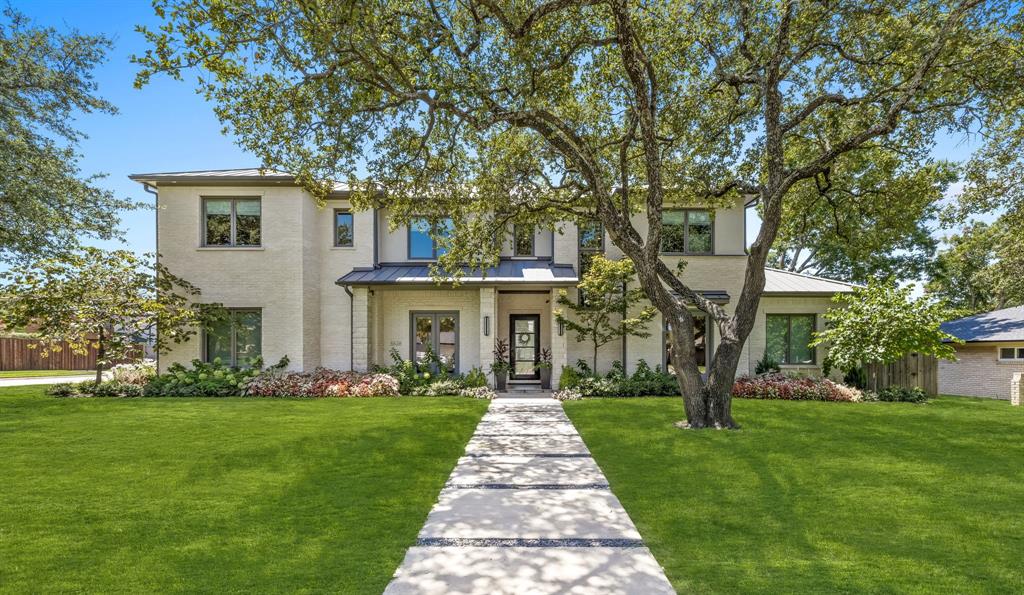 a front view of house with yard and green space