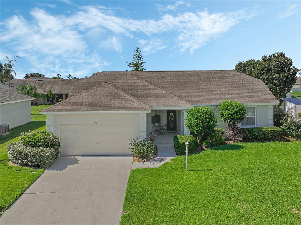 a house with green field in front of it