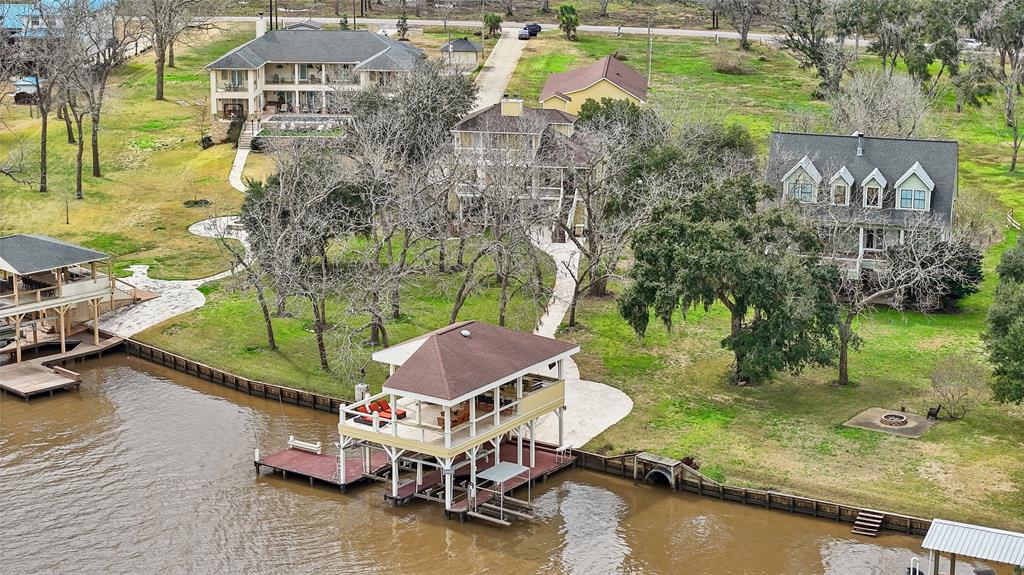 Discover the allure of riverside living with this breathtaking property, featuring spacious acreage with mature trees and an expansive private dock perfect for hosting and enjoying the waterfront lifestyle.