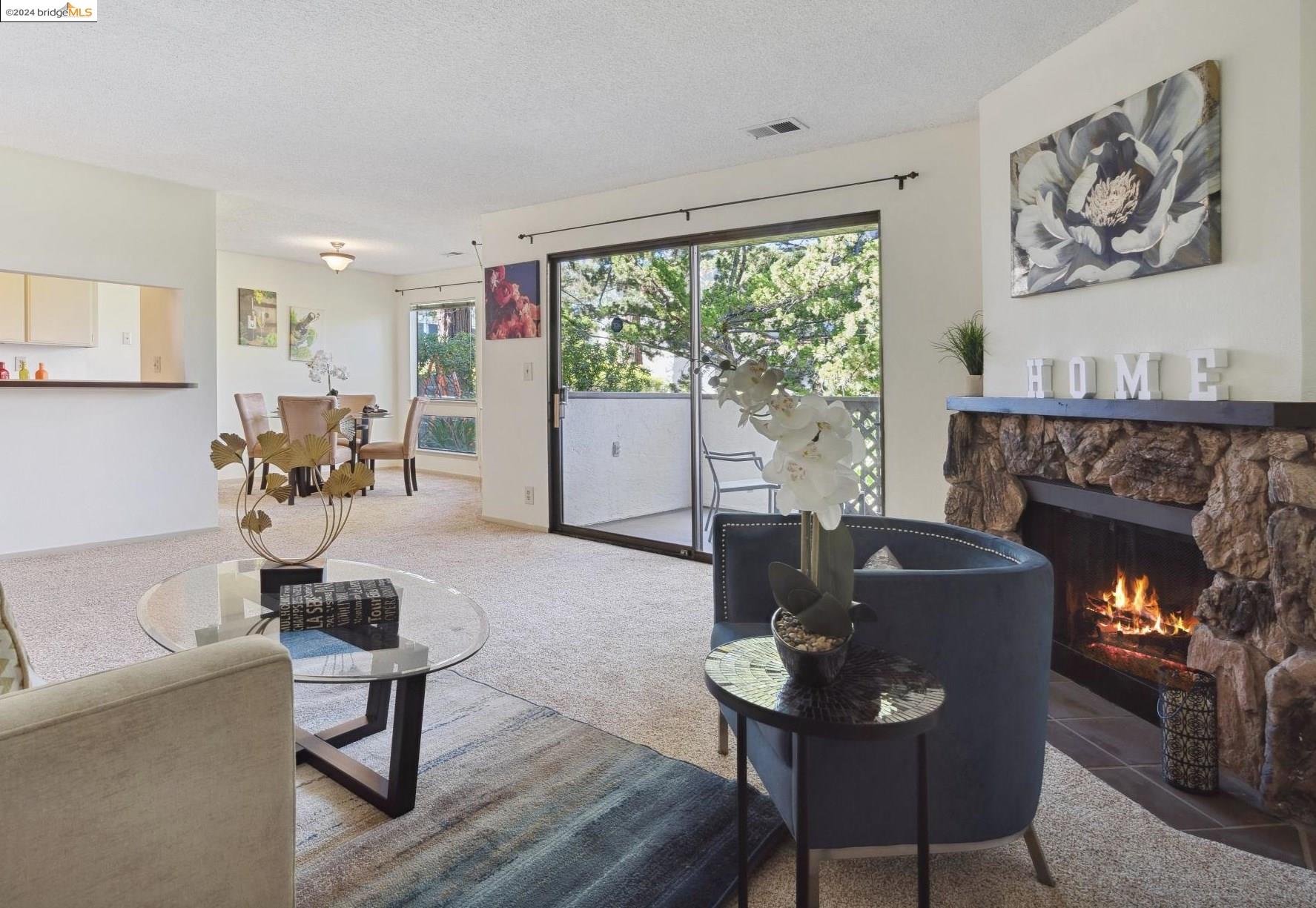 a living room with furniture a window and a fireplace