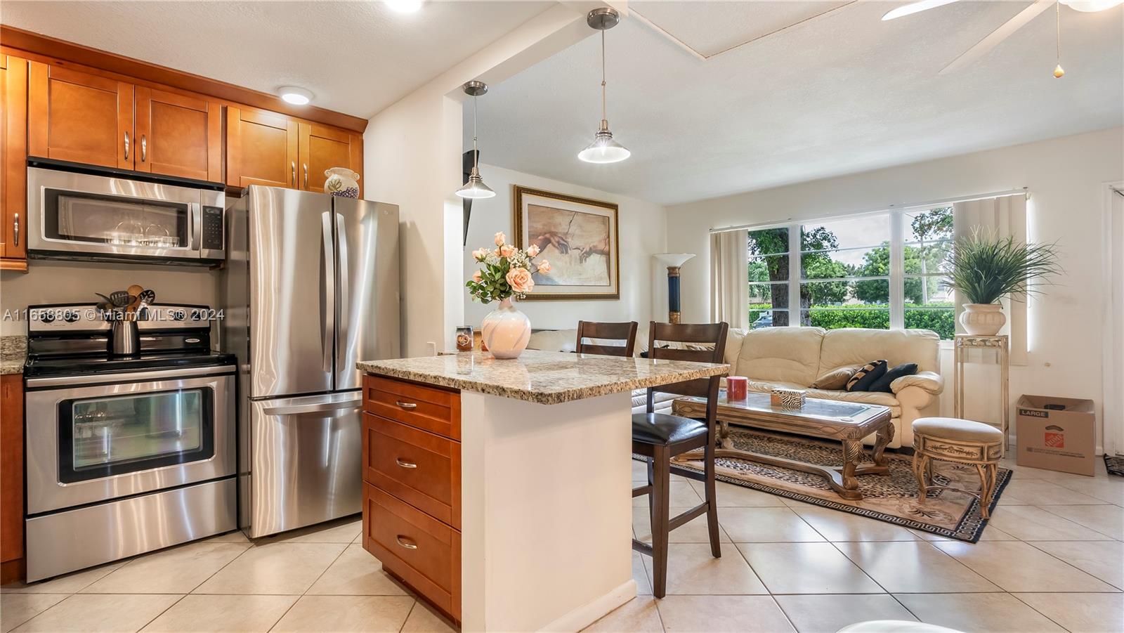 a kitchen with stainless steel appliances granite countertop a stove refrigerator and microwave