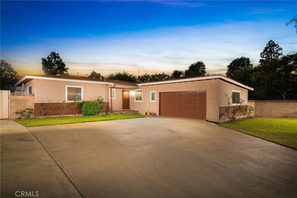 a view of a house with a yard and garage