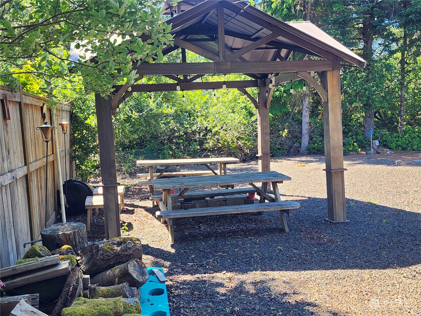 a view of a patio with a table chairs and a backyard