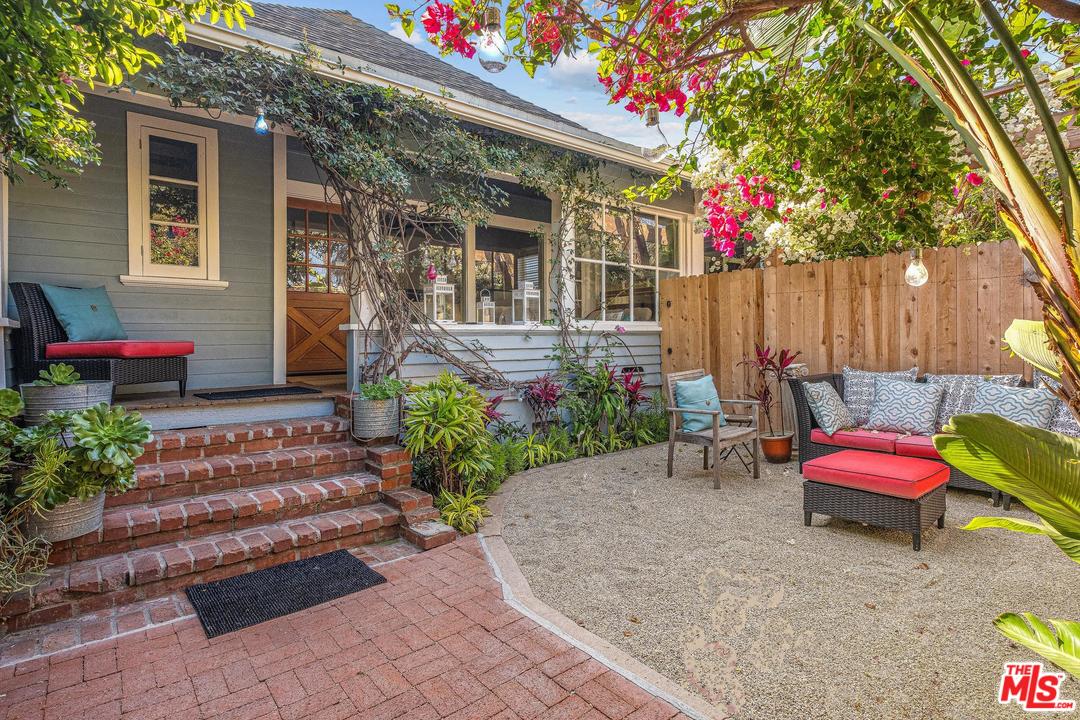 a view of a house with a backyard and a chair and fire pit