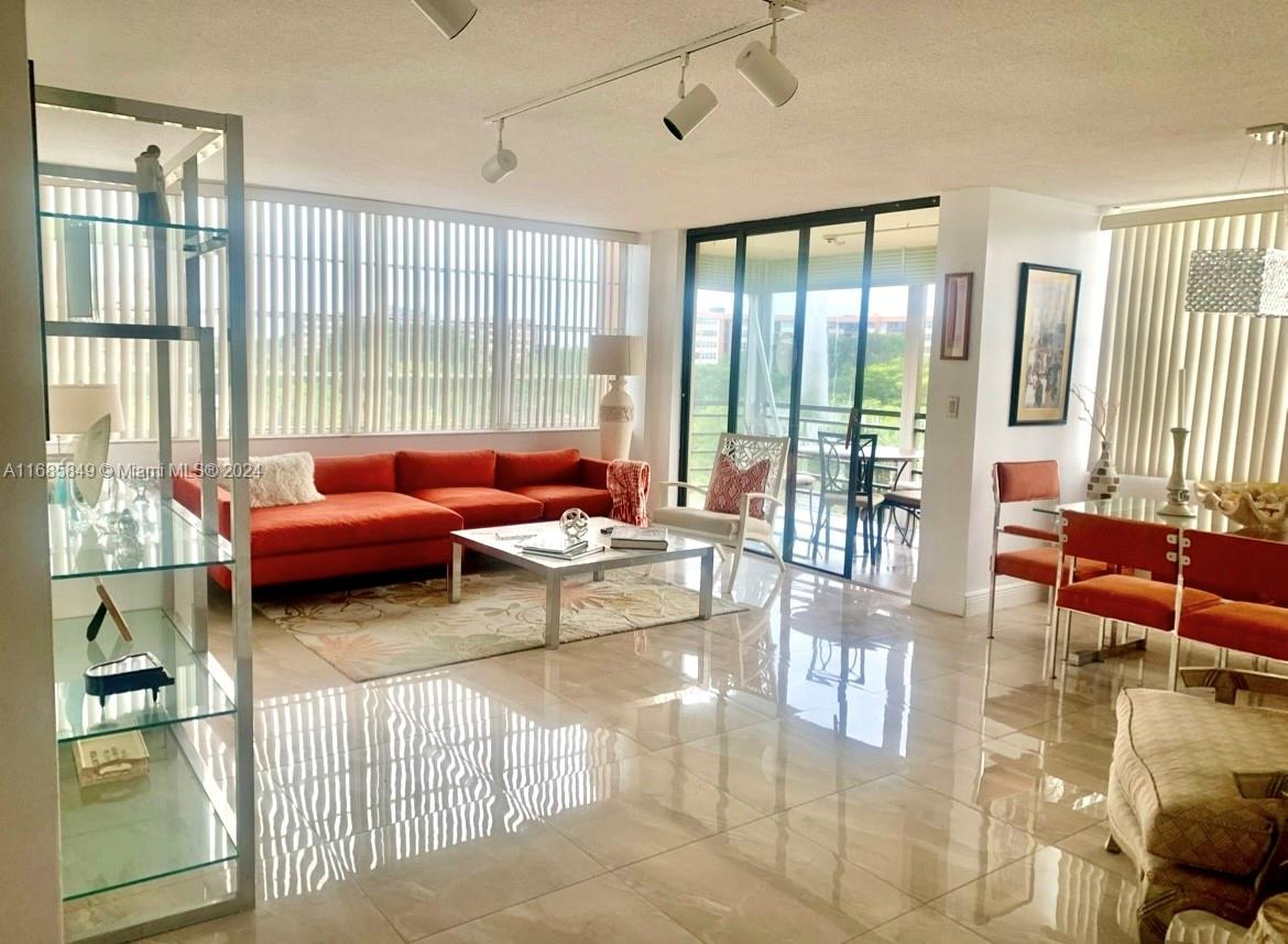 a living room filled with furniture and a large window