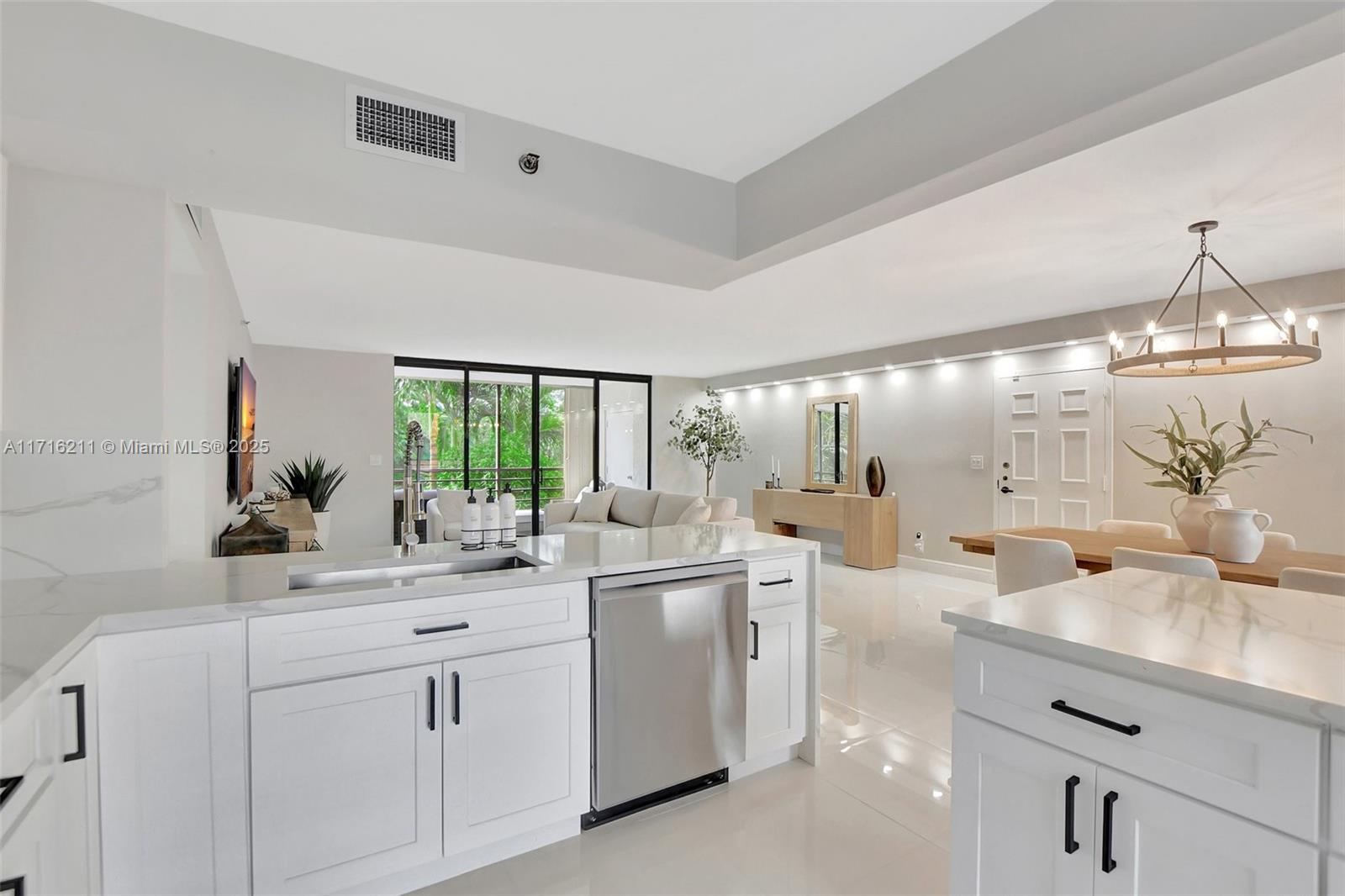 a kitchen with sink attached with living room