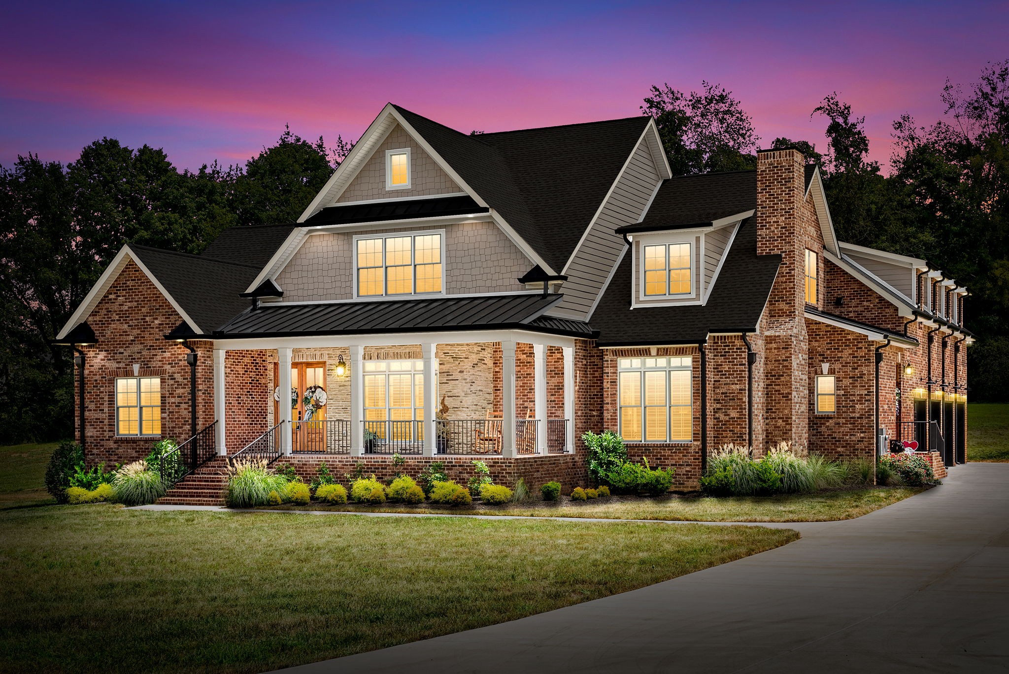 a front view of a house with a garden and pathway