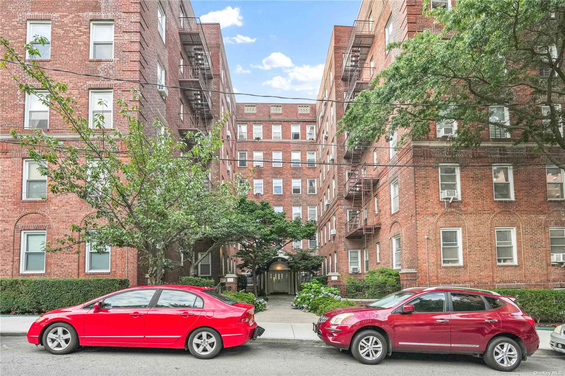 a cars parked in front of a brick building