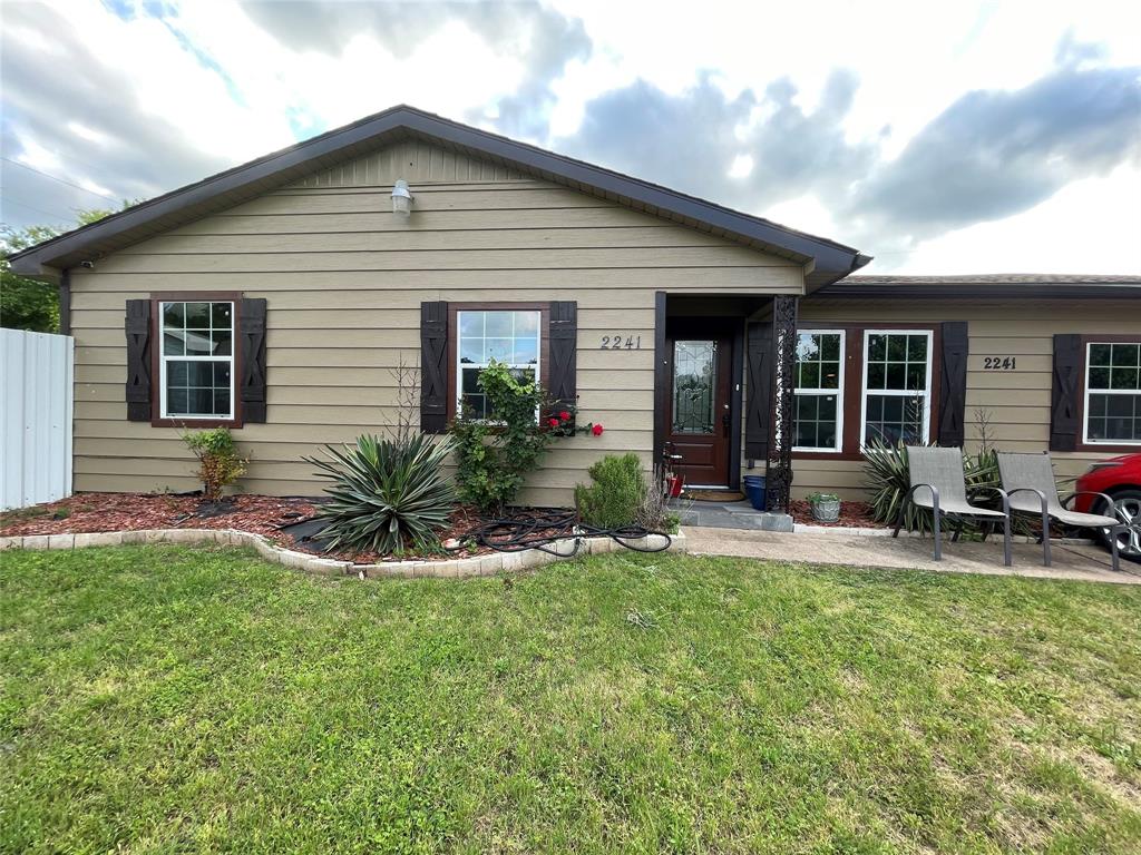 a front view of a house with patio and yard