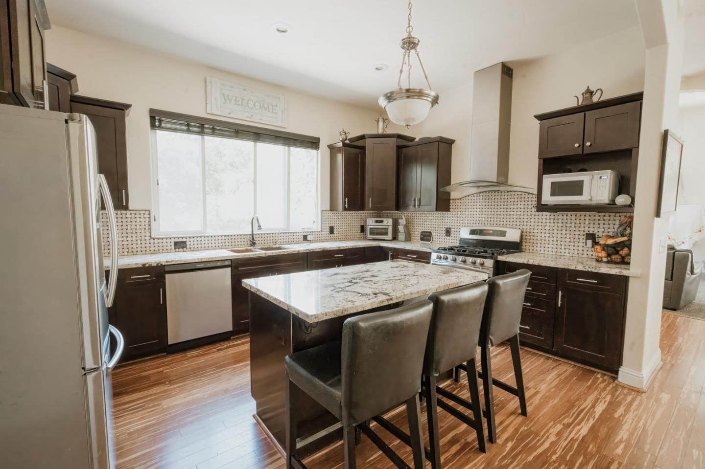 a kitchen with granite countertop a sink appliances cabinets and counter space