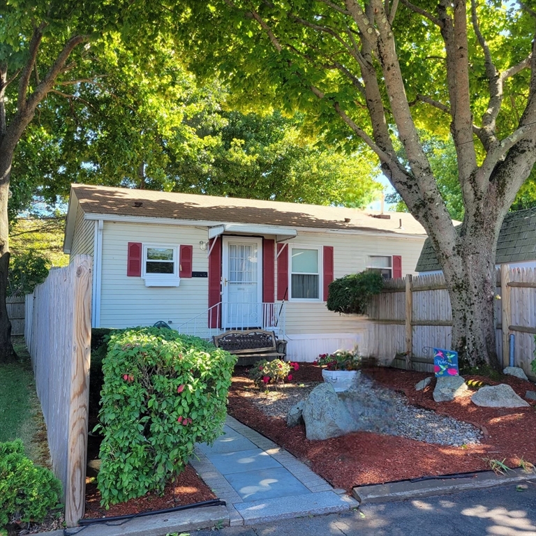 a view of a house with backyard and sitting area