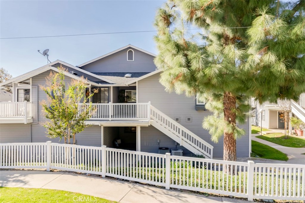 a front view of a house with wooden fence