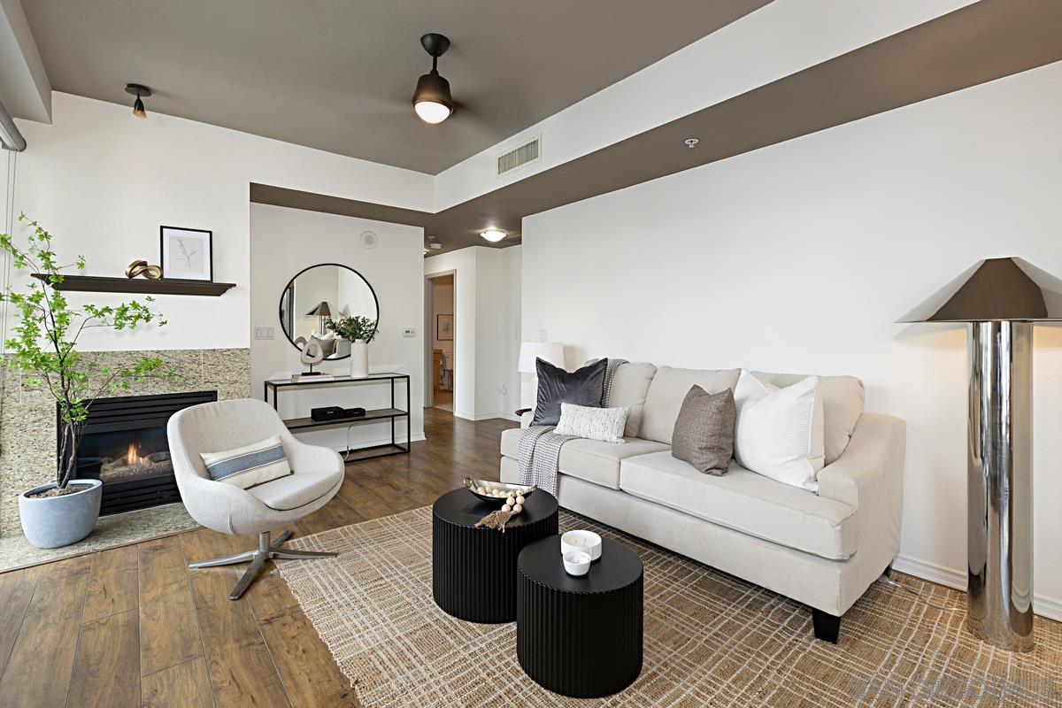 a living room with furniture and a wooden floor