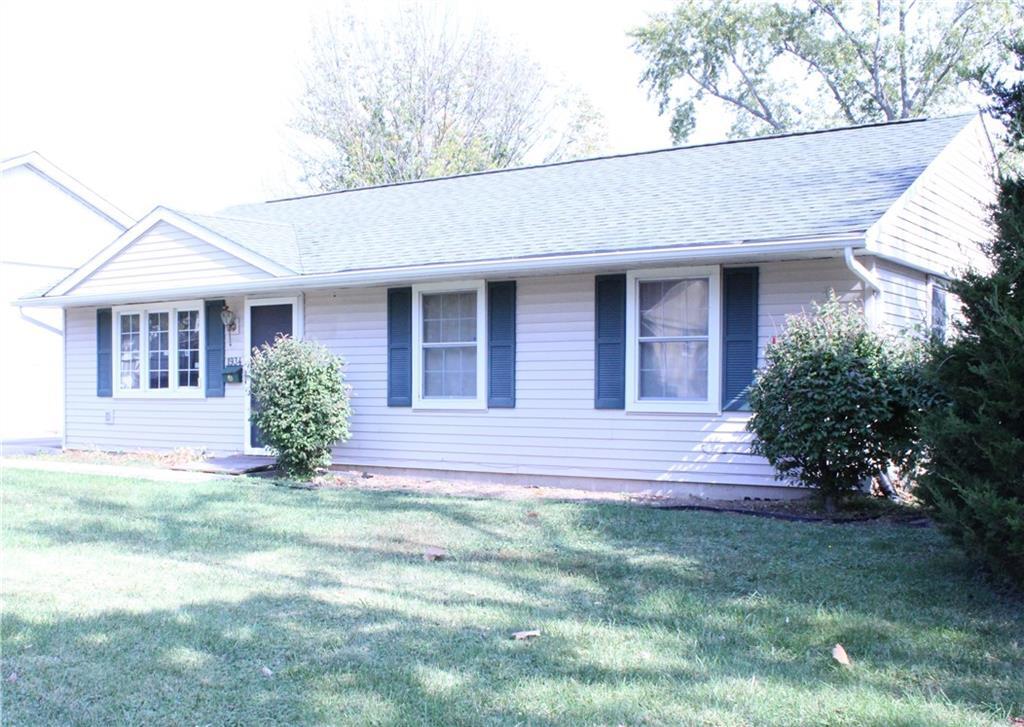 a view of a house with a yard and plants