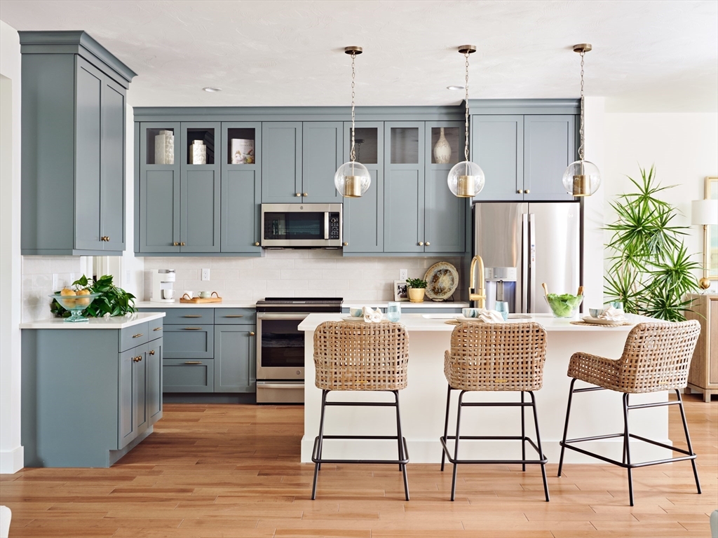 a kitchen with a table chairs microwave and cabinets