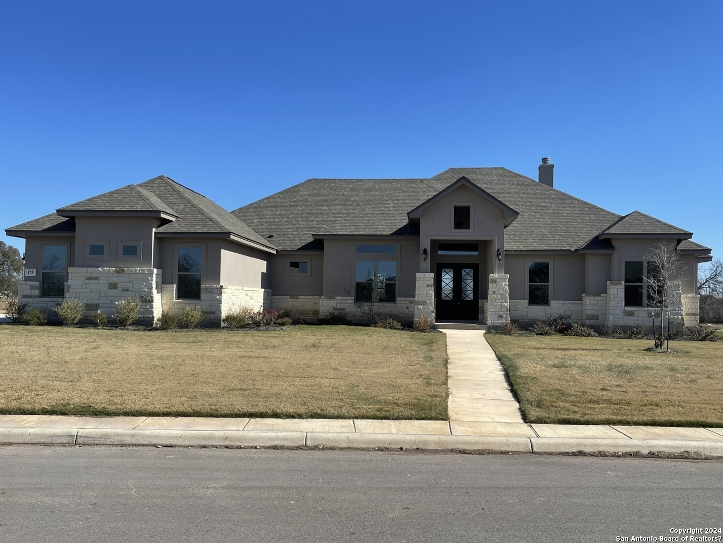 a front view of a house with a yard