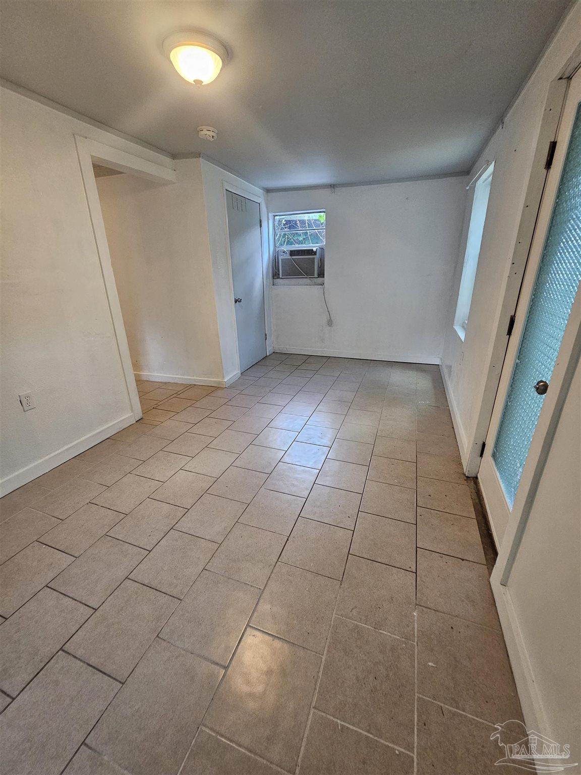 a view of an empty room and a window