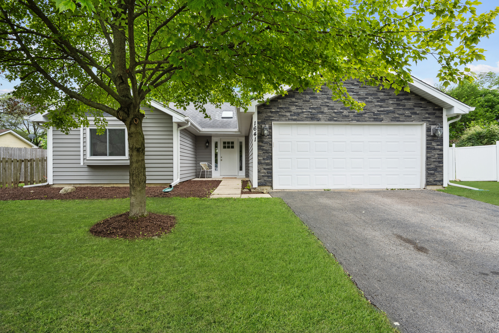 a front view of house with yard and green space